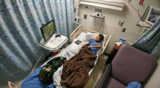 a child playing on a Gamers Outreach Go Kart in a hospital