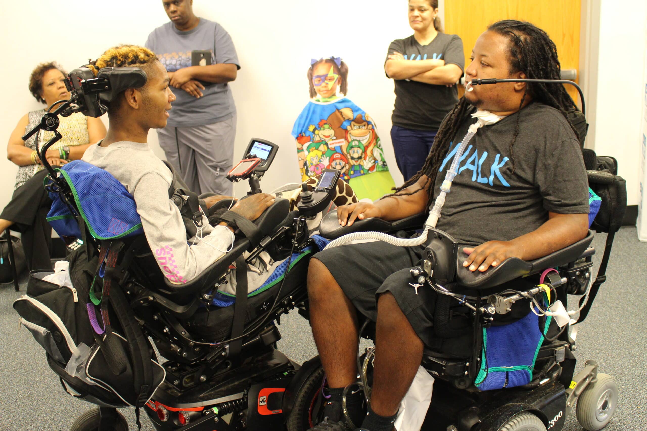 New Orleans Hospital To African-American power wheelchair users, meeting and challenging each other to a game using a quadstick.