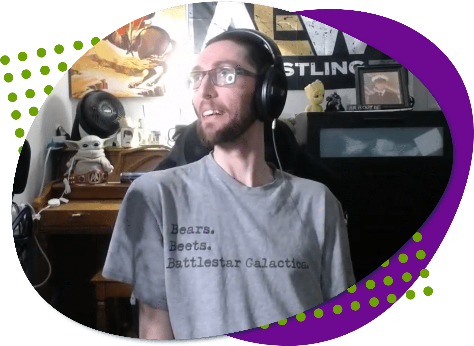 Anthony stack pic A photo of Anthony, he is wearing glasses, a headset and a gray t-shirt that says bears, beets, battlestar galactica