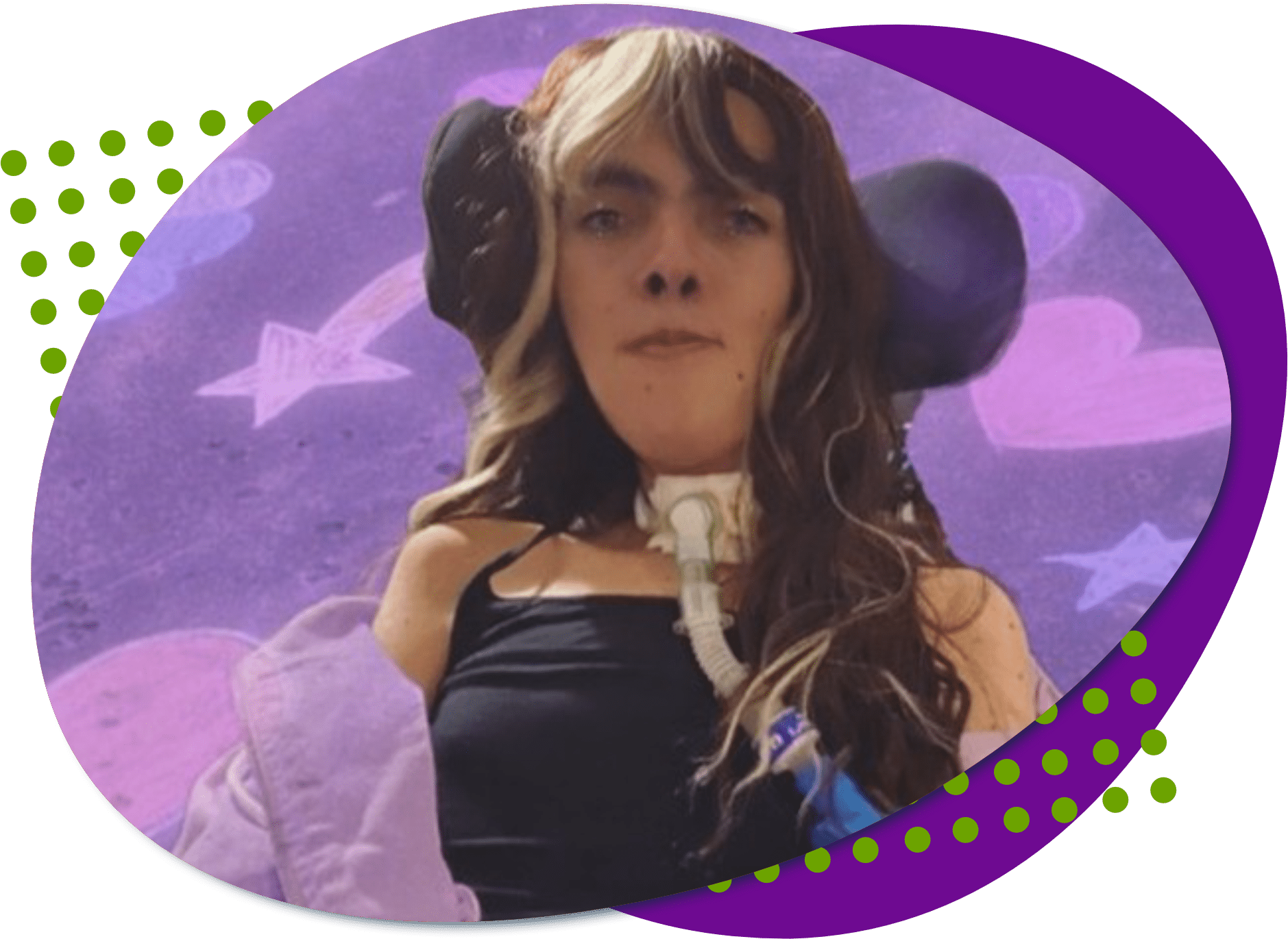 A photo of Christine, she has long brown hair and is wearing a black tank top and purple hoodie