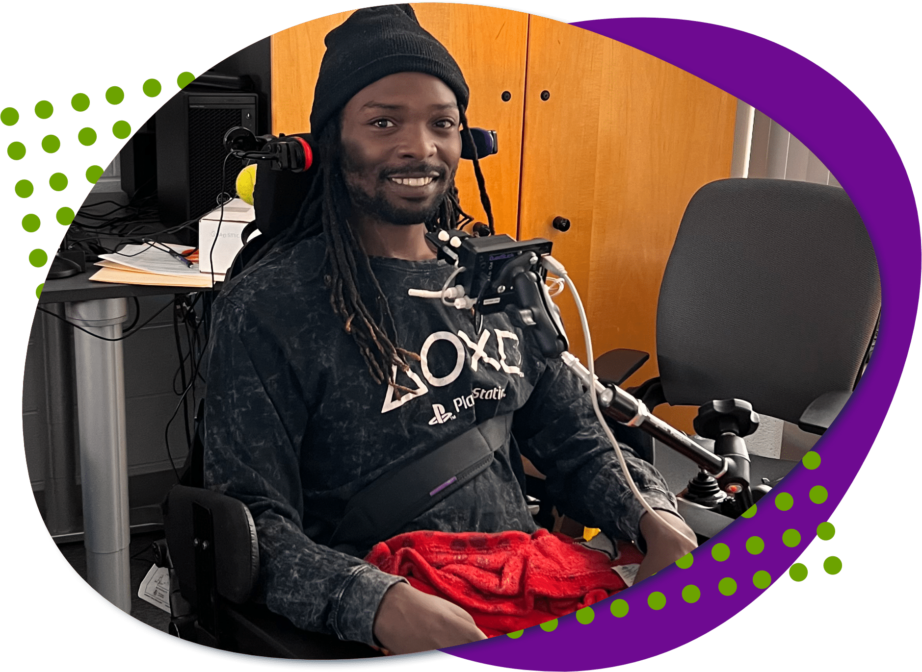 A photo of Damion with his adaptive gaming equipment, the QuadStick