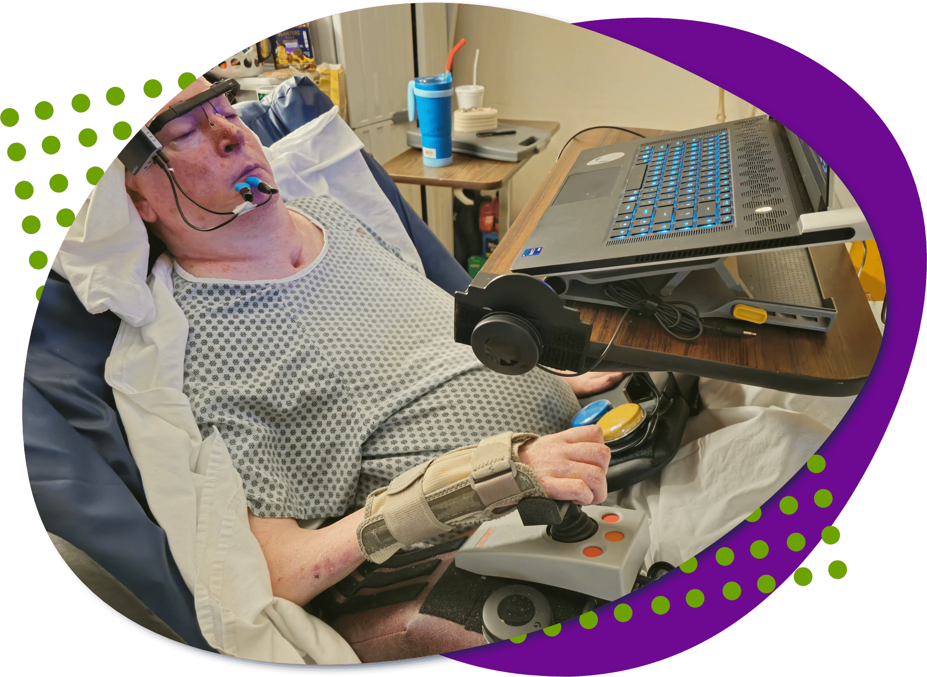 david stack logo A photo of David using a joystick and buttons to play a video game on his laptop