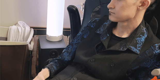 Eagle H, Dressed in black is playing a game using his custom controller.