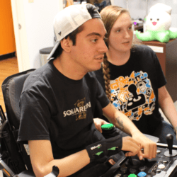peer counselor helping a young man find the right adaptive controller