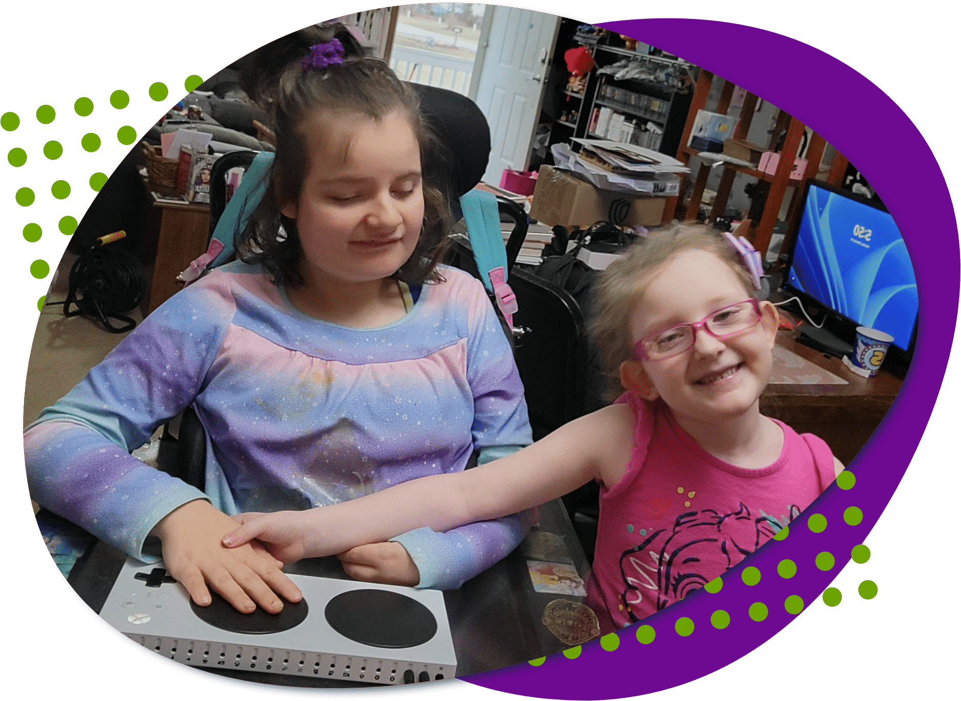 A picture of Jolee with her new gaming setup her sister is standing beside her