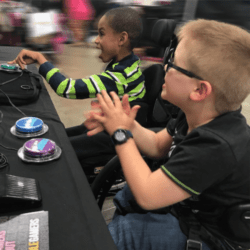 Two young boys playing video games together