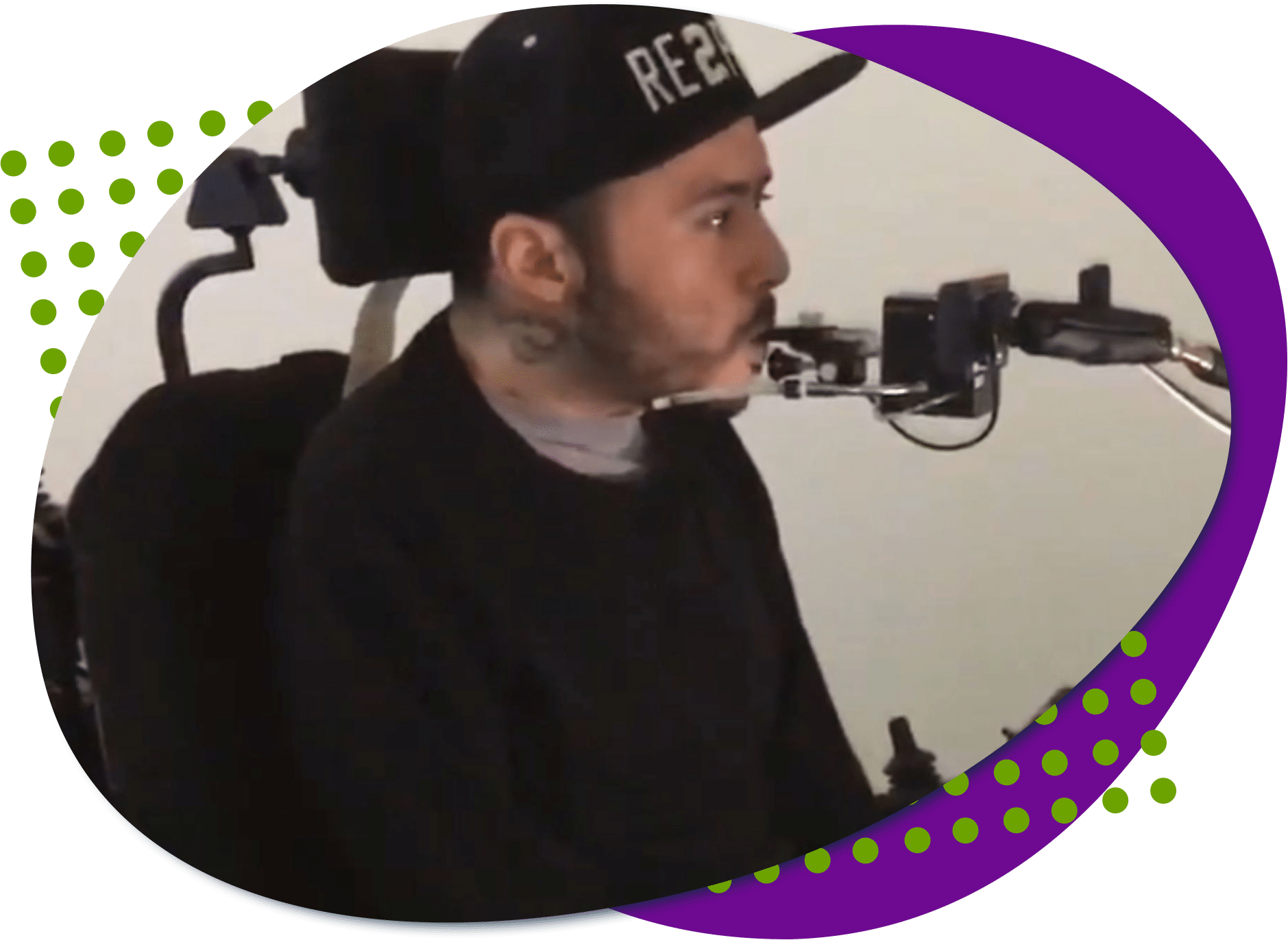 Walter stack image Walter is wearing black and is in a wheelchair, he is blowing into a quadstick.